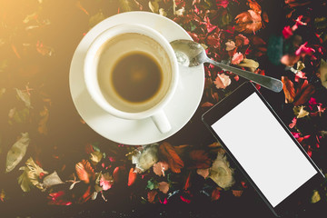 Coffee cup with smartphone blank screen on flowers background ,