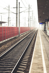 Fototapeta premium lonesome railway tracks in austria at a misty morning
