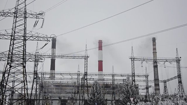 Power lines in the snow. Cogeneration plant in a strong blizzard