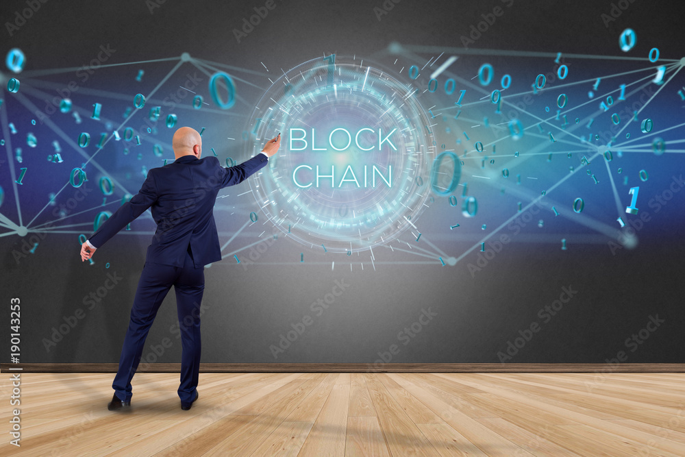 Poster businessman in front of a wall with blockchain title with 0 and 1 data flying over
