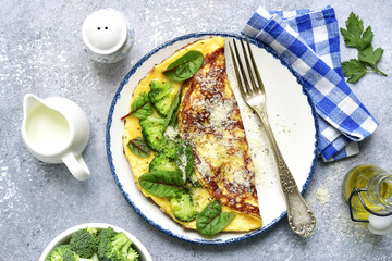 Omelette stuffed with broccoli, cheese and chard leaves for a breakfast.Top view.