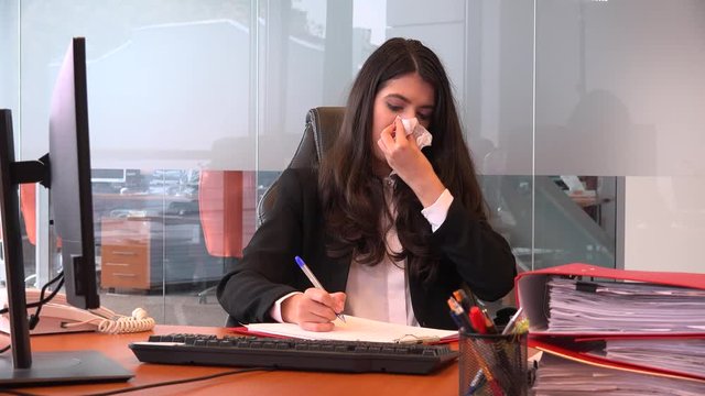 Good looking businesswoman young person blowing nose inside office accountant 4K