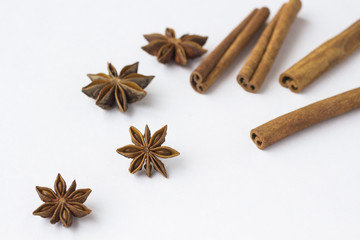 Spices: star anise and cinnamon sticks on white background. Close up.
