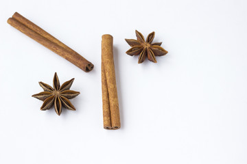 Spices: star anise and cinnamon sticks on white background. Close up.