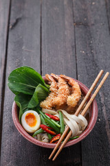 Tempura shrimps with asian noodle soup in a bowl