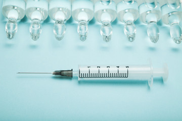 Liquid medication in ampoules and a syringe.