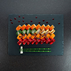 Sushi Set nigiri and sushi rolls on gray stone slate on metal background