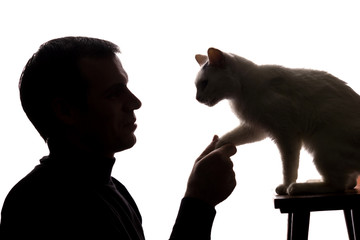 Young man play with a kitten