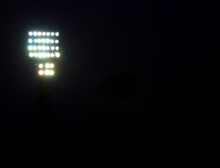 headlights lit in a stadium