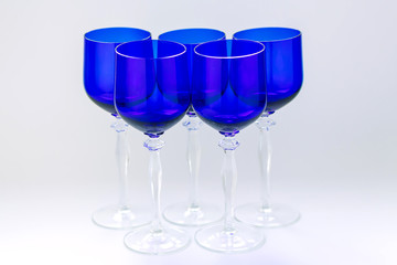 Five blue wine glasses