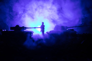 Fototapeta na wymiar War Concept. Military silhouettes fighting scene on war fog sky background, World War Soldiers Silhouettes Below Cloudy Skyline At night. Attack scene. Armored vehicles. Tanks battle.