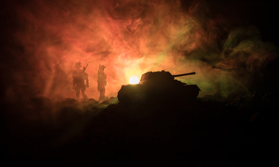 War Concept. Military silhouettes fighting scene on war fog sky background, World War Soldiers Silhouettes Below Cloudy Skyline At night. Attack scene. Armored vehicles. Tanks battle.