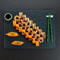 Sushi Set nigiri and sushi rolls on gray stone slate on metal background