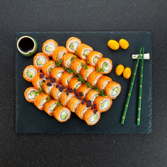 Sushi Set nigiri and sushi rolls on gray stone slate on metal background