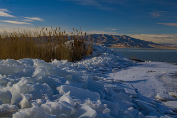 1/27/2018-Benjamin, Utah/USA- Ice sheets stacked along the edge of Utah Lake creating a tranquil feeling