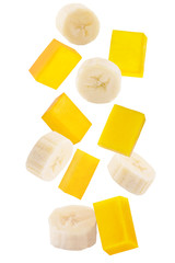 Falling sliced banana and mango isolated on white