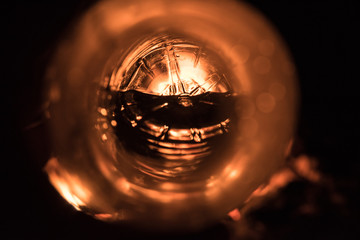 Abstract image of a circular item lit by a fire. 
