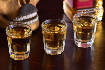 Tequila shoots on dark background