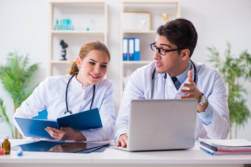 Male and female doctor having discussion in hospital