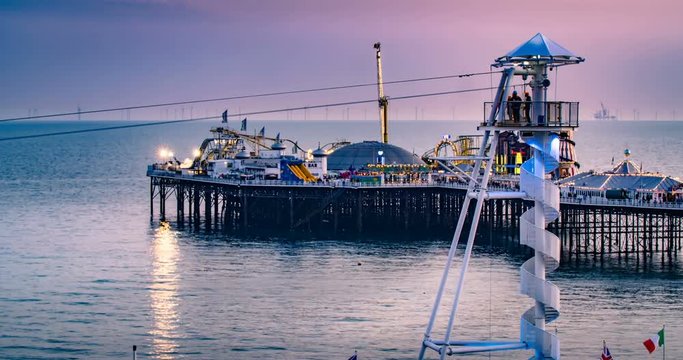 Time lapse view of people riding on the new zip line attraction on the seafront in Brighton