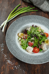 Mixed Green Salad with Grilled Salmon and Quinoa on Wood Background/ Selective Focus