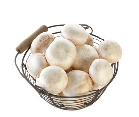 Basket with champignon mushrooms on white background