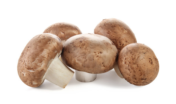 Raw cremini mushrooms on white background