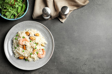 Plate with delicious seafood risotto on table