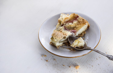 plate with apple pie and spoon on white table 