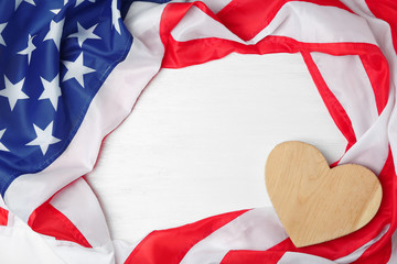 Wooden heart and American flag on light background. USA holiday