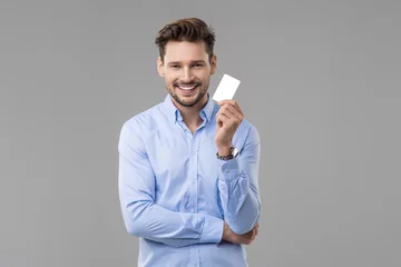 Handsome man in blue shirt  with white card © Aarrttuurr