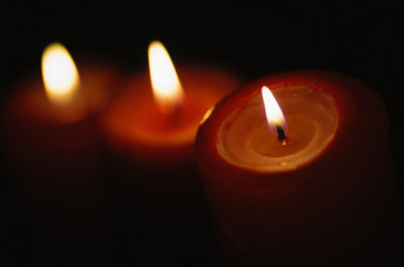Beautiful candles burning on a black backgrounds