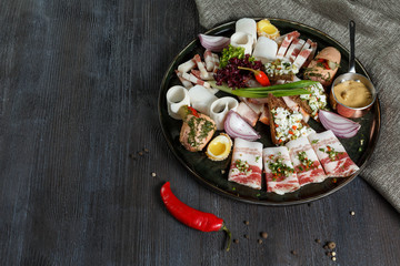 Lard plate with salt cucumbers and marinated garlic.
