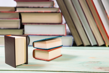 Pile of various books on wooden background. With copy space for your text