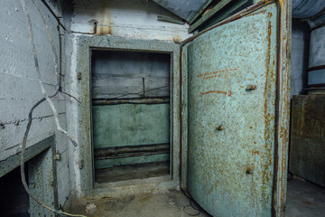 Old rusty steel armored door in abandoned soviet military bunker