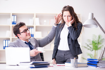 Sexual harassment concept with man and woman in office