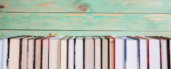 Pile of various books on wooden background