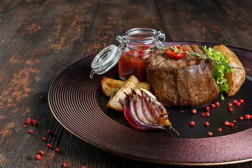 steak medallion. restaurant food. wood background