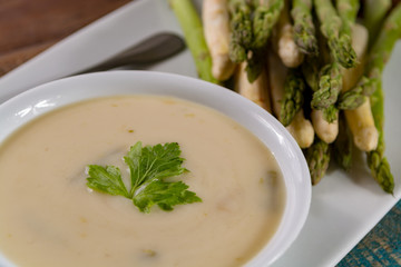 Seasonal fresh homemade asparagus soup made from white and green asparagus vegetables