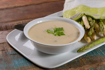 Seasonal fresh homemade asparagus soup made from white and green asparagus vegetables