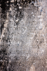 Ancient Greek text background. Letters carved in stone. Selcuk in Turkey