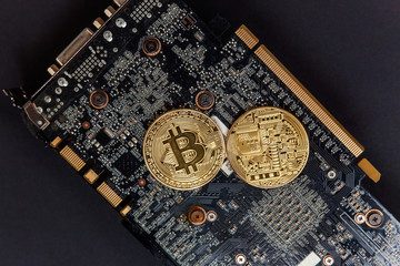 Bitcoins lie on the video card, concept of mining. Electronic virtual money for web banking and international network payment. Symbol of crypto currency