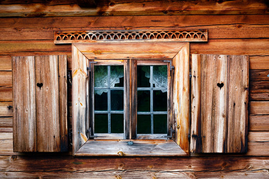 Old windows with shutters. Rustic wooden house