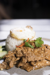 Thai garlic pork stir-fry with white rice topped with fried egg