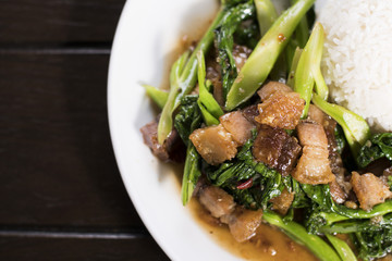 Chinese broccoli and crispy pork belly stir fry over rice