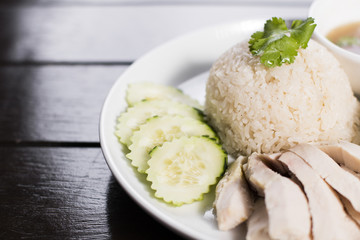 Steamed chicken served over ginger jasmine rice with a side of chicken broth and homemade fermented soy bean sauce