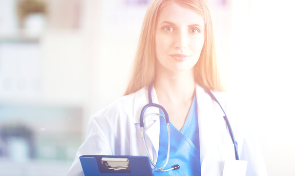 Doctor  woman is standing in the near window 