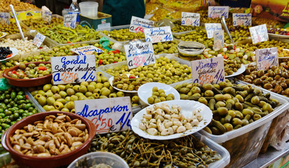 Assortment of olives and pickles at market stand