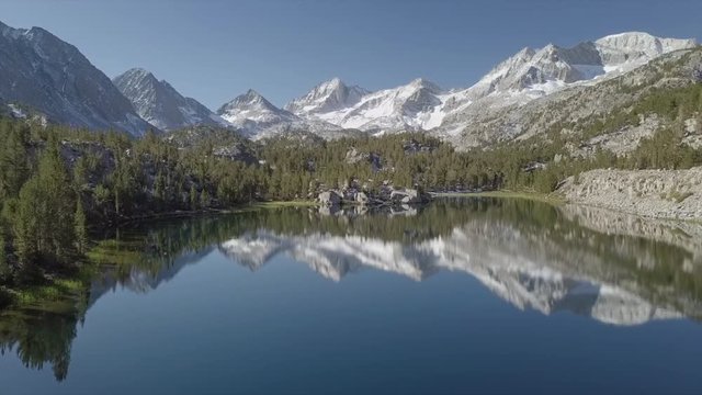Epic Aerial Reveal Snow Mountain Valley with Mirror Lake reflection - Inyo National Forest, Little Lakes Valley Trail (Gem Lakes), Bishop, California
