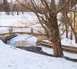 Freezing river under the stone bridge